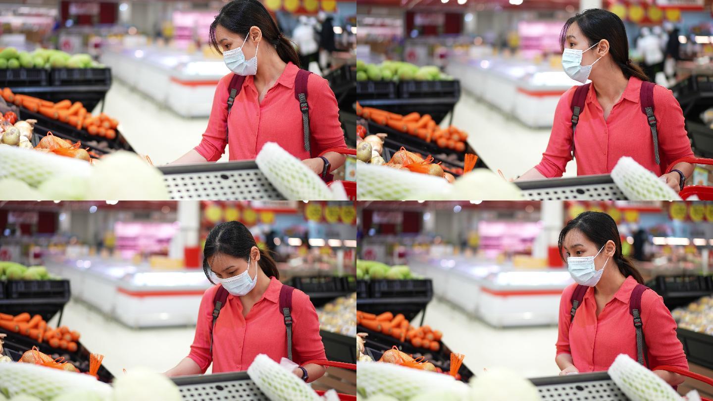 亚洲女性戴防护面具在超市购物