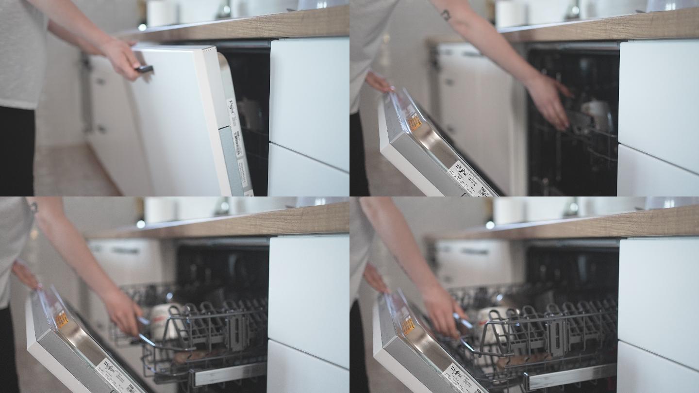 女性手打开洗碗机的特写图