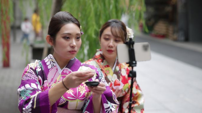 穿着和服的年轻女性朋友在街上吃美食