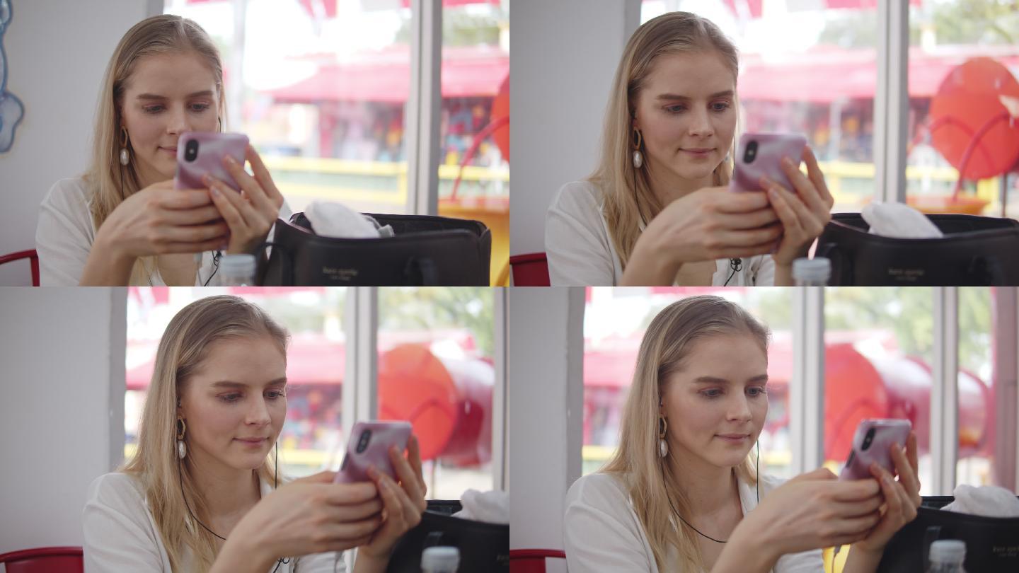 在咖啡馆使用智能手机的女子，追踪镜头