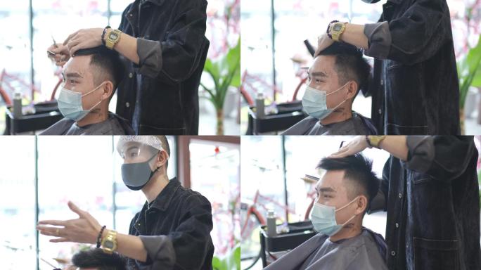 亚洲华人发型师，穿着防护服，在美发沙龙为顾客剪头发