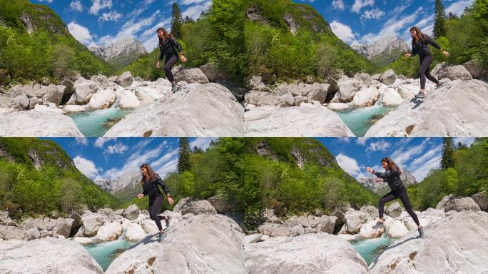 年轻女子穿越山河，从一块岩石跳到另一块岩石