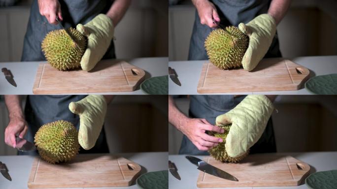 家中厨房的砧板上打开榴莲泰国热带水果的人