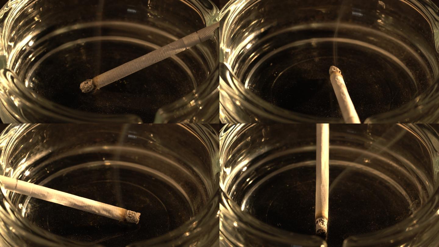 用烟灰缸燃烧香烟点燃的香烟在烟灰缸里烟草