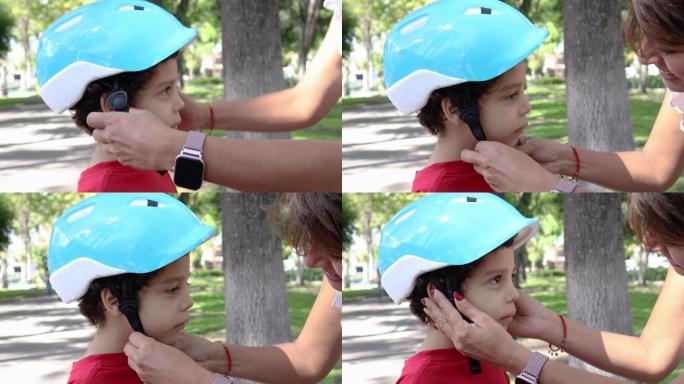 母亲给儿子戴自行车头盔