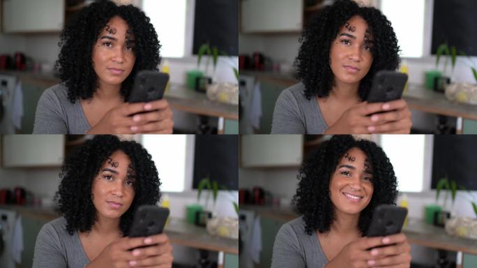 一位年轻女子在家里用智能手机发短信的照片