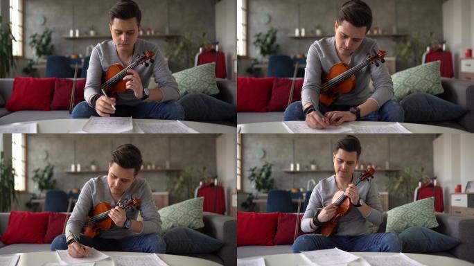 男小提琴家在家沙发上作曲