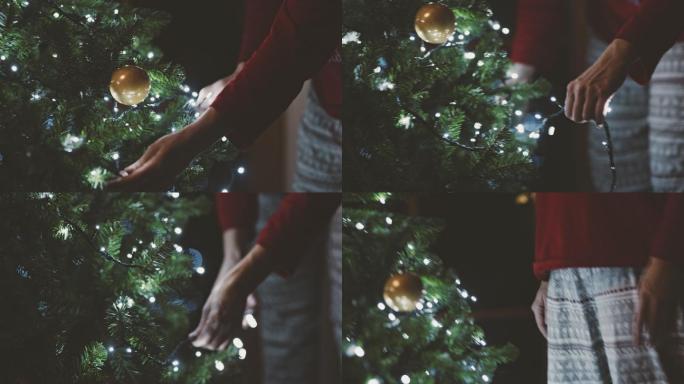 MS女士在圣诞树上放线灯