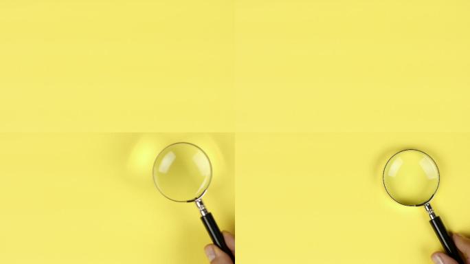 手动将放大镜放置在黄色背景上，以显示搜索或调查