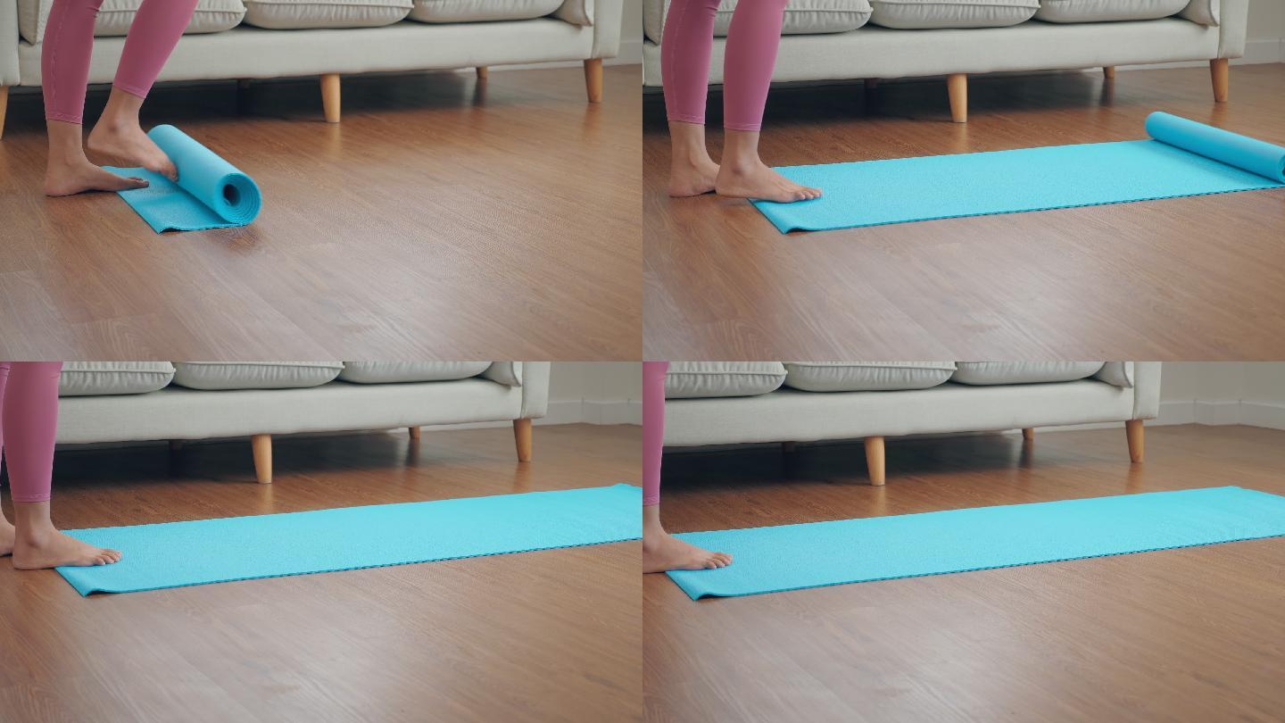 特写镜头：一位女士在蓝色瑜伽垫上伸展双脚