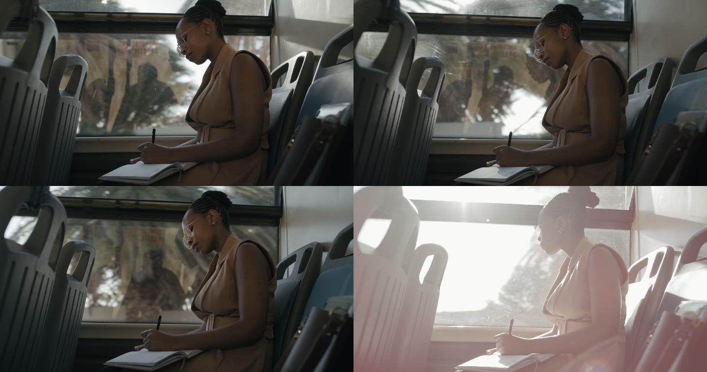一名年轻女商人乘公共汽车旅行时在笔记本上写字的4k视频片段