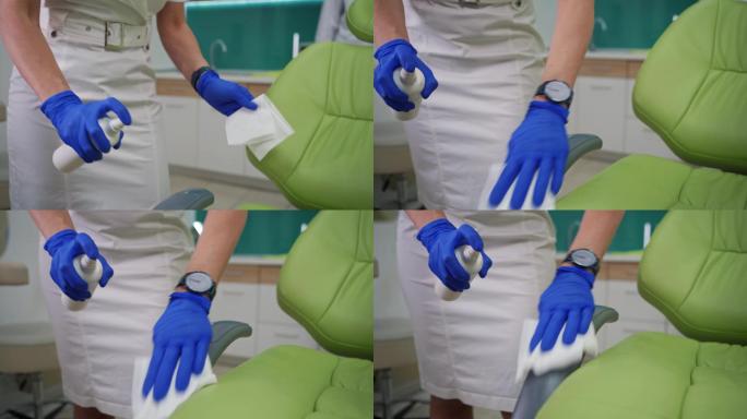 女牙医在她的现代圣职中为每位患者清洁牙医的椅子