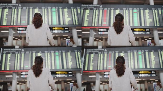 亚洲女性看着机场登机牌
