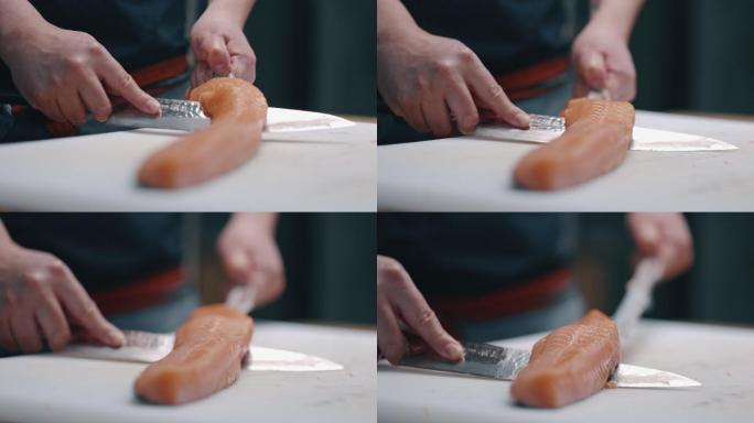 日本厨师切割和准备生鲑鱼制作寿司