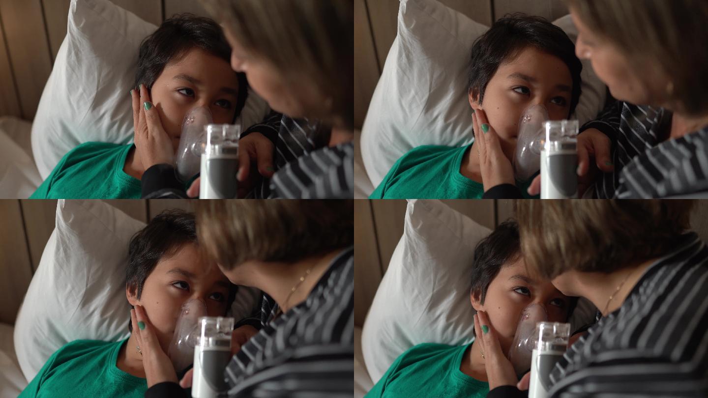 母亲帮助儿子在家床上进行吸入治疗时使用雾化器