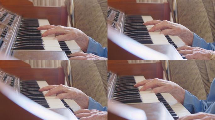 一位老妇人在家中弹奏钢琴键盘的手持式照片