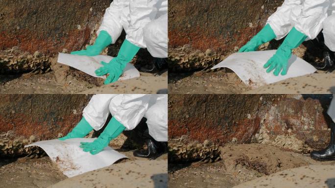 污染控制团队PPE套装致力于清理海滩溢油补贴