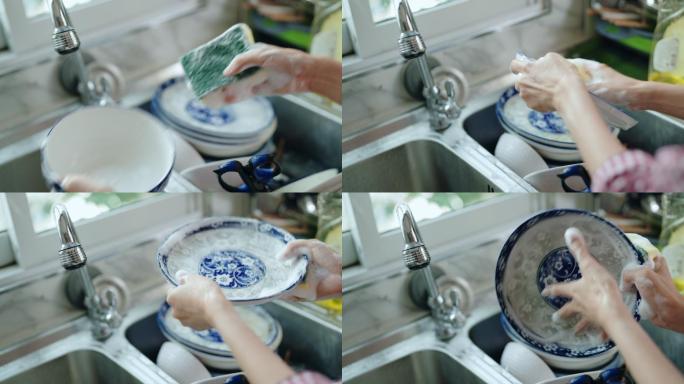 在家洗碗的女人。刷碗碟