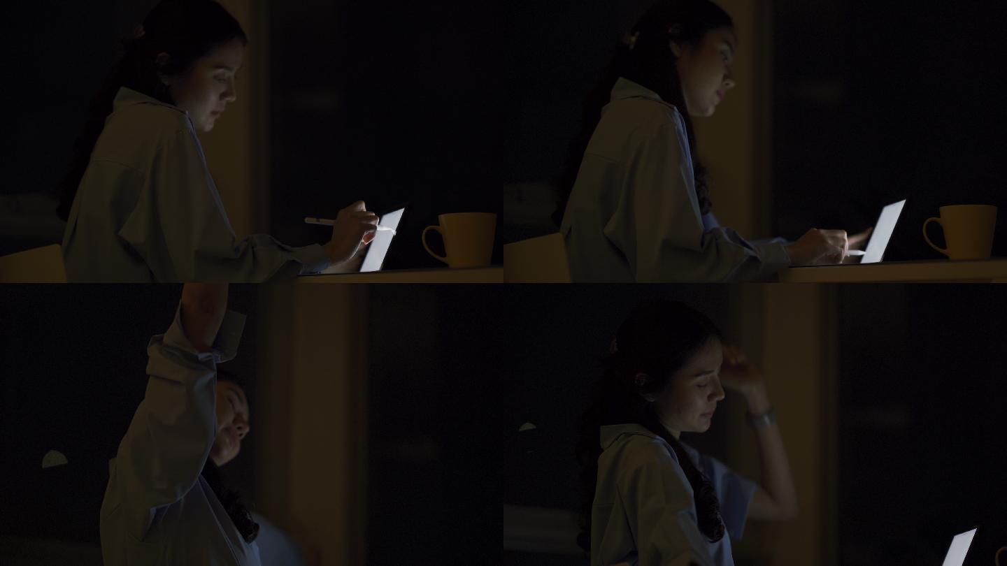 年轻的亚洲女性晚上在卧室和阳台上使用数字平板电脑。