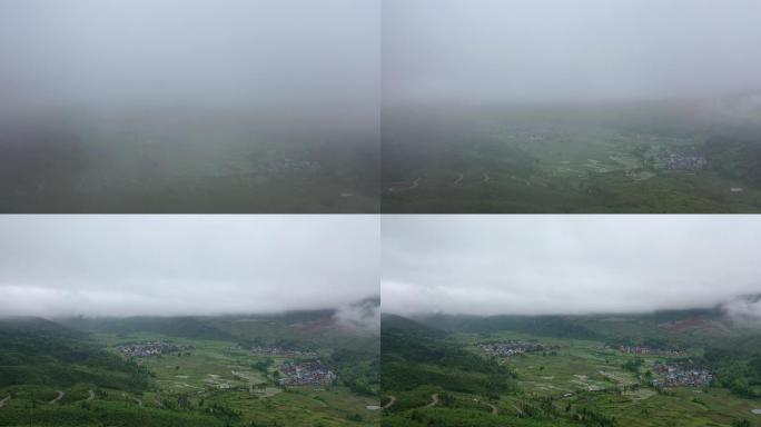穿过云雾出现在山谷中的村落