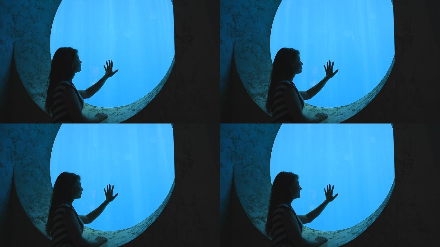 浪漫女孩欣赏水族馆的水下世界