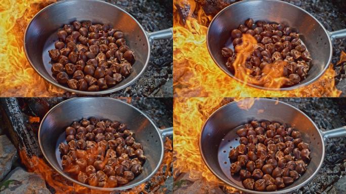 SLO-MO火苗在烤栗子的锅下燃烧