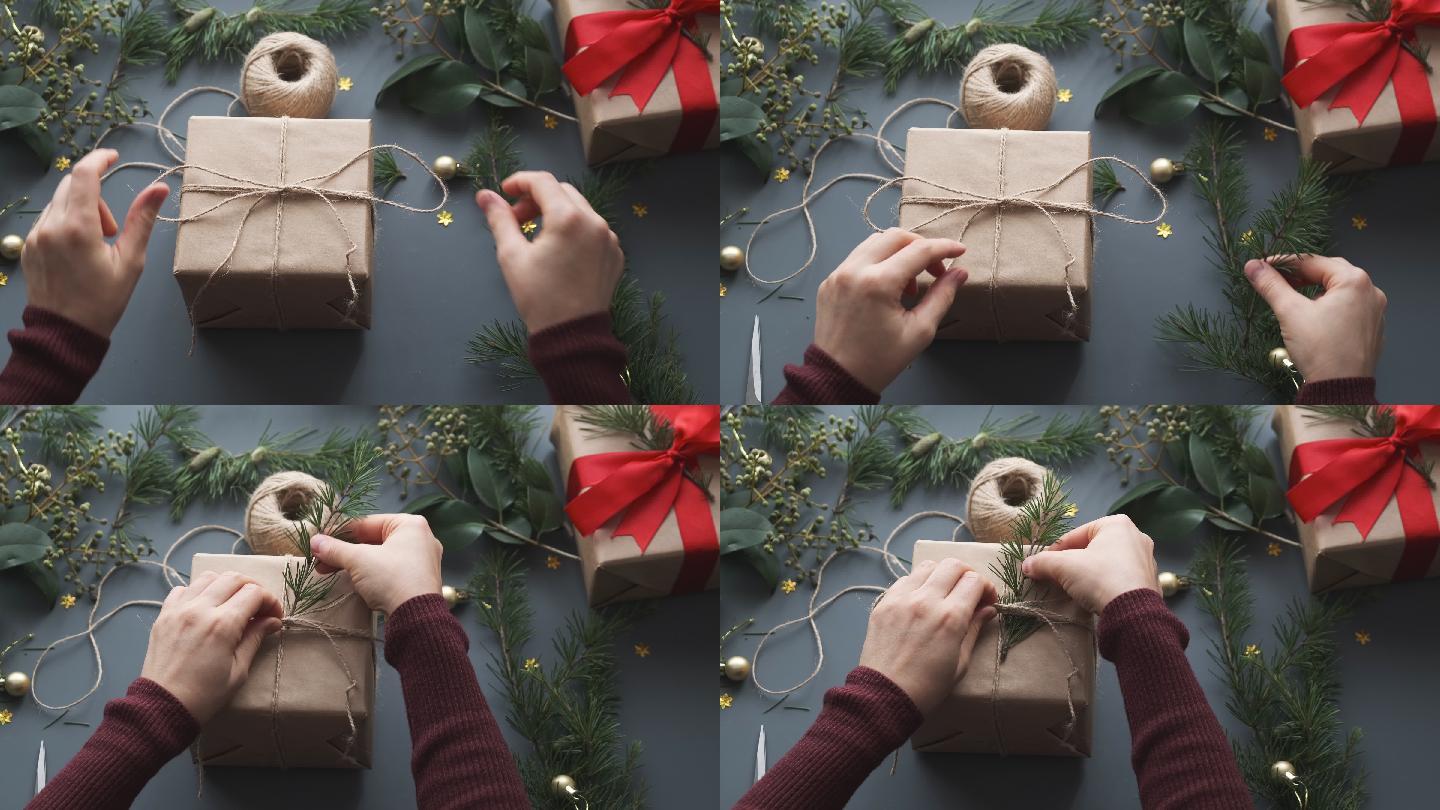 准备圣诞礼物的女人。圣诞背景、礼品盒和松枝