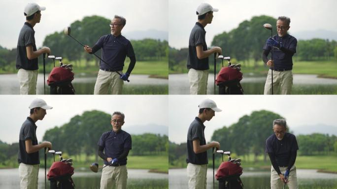 亚裔中国父亲在高尔夫球场教儿子打高尔夫球