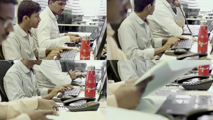 印度人在办公室的电脑桌上工作
