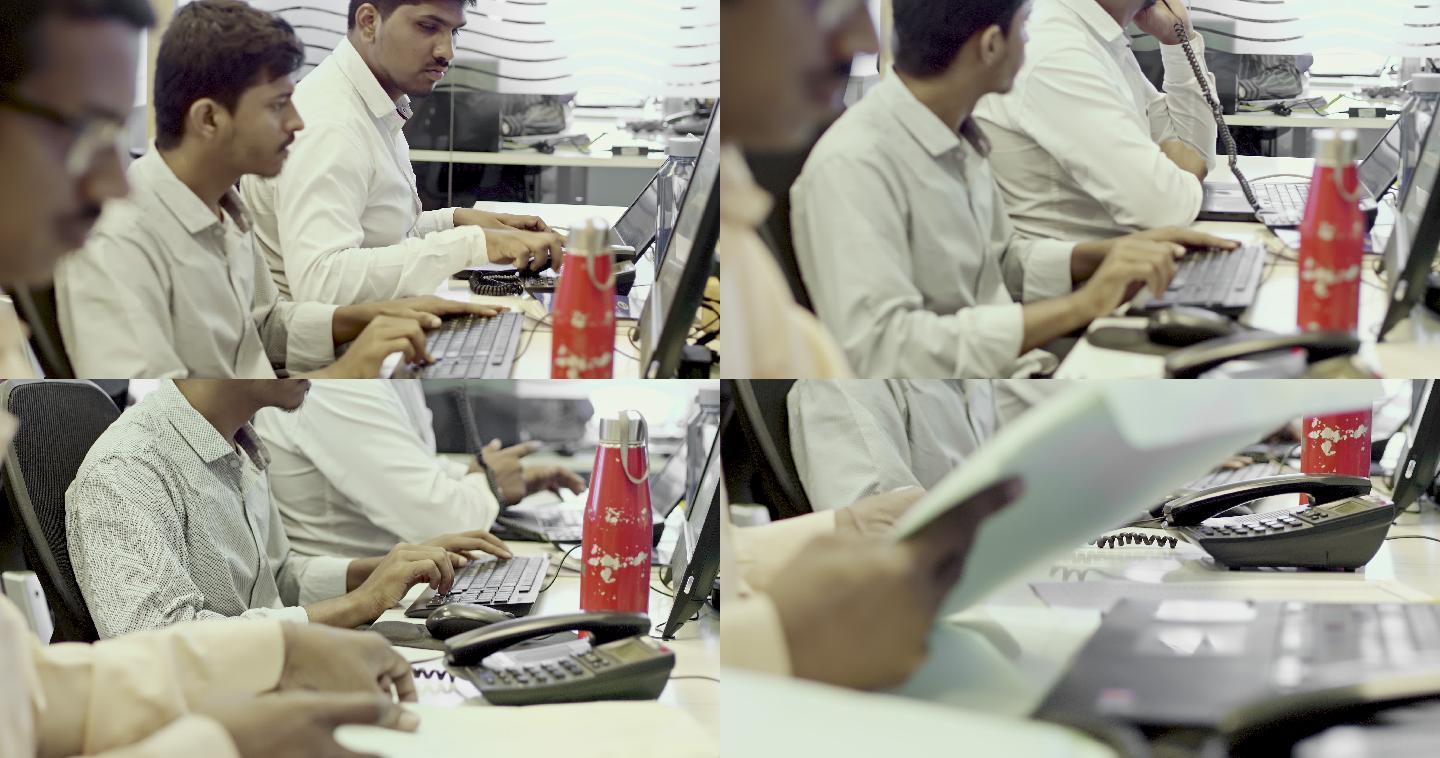 印度人在办公室的电脑桌上工作