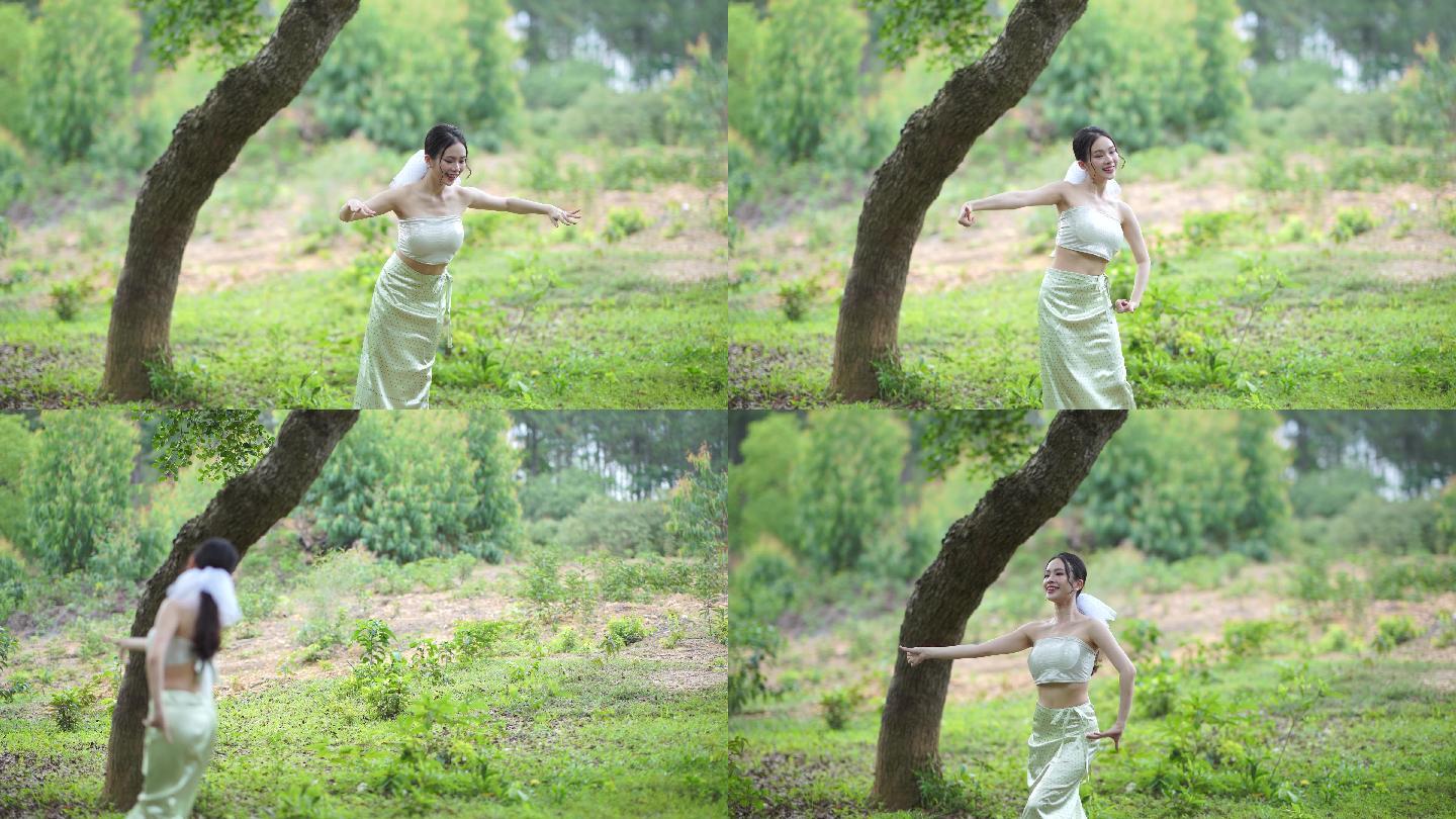 傣族少女在树林下跳舞