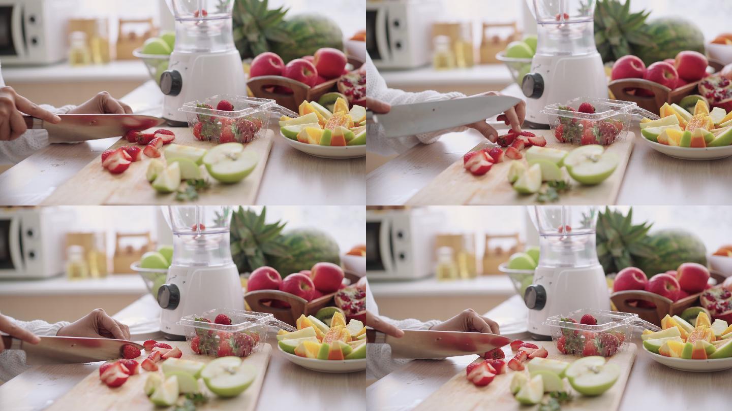 准备用草莓、苹果、橘子和石榴制作自制冰沙，由高级女士手将水果切成小块，侧视图