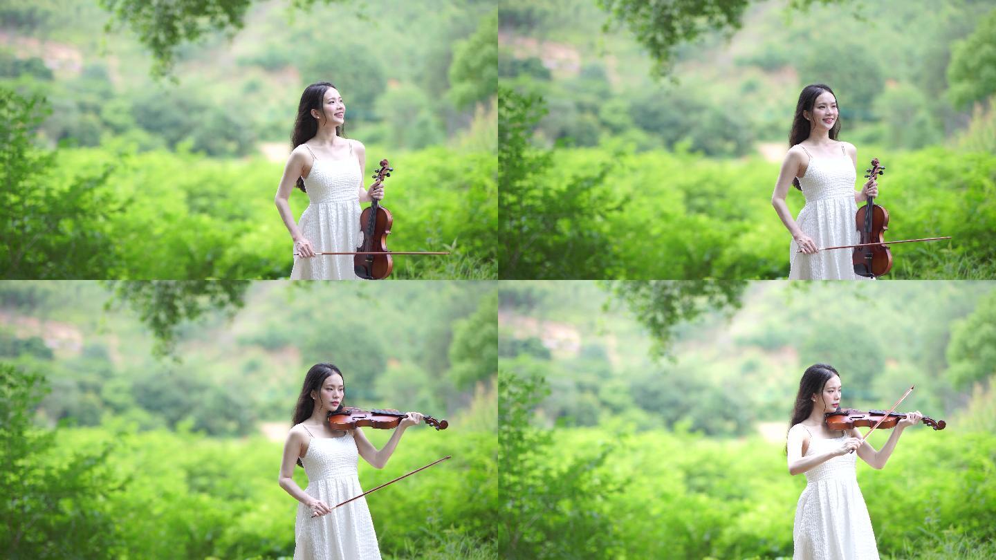 女孩在树林下拉小提琴