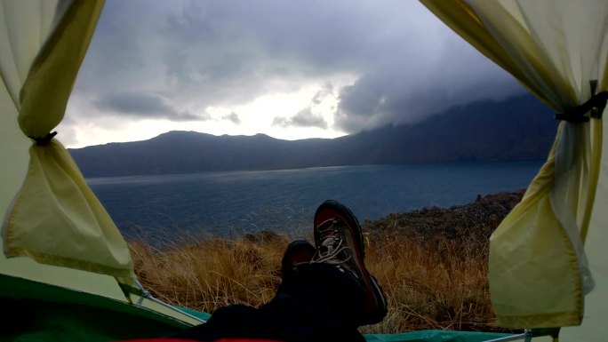 内姆鲁特火山口湖附近的帐篷里有风、云和雨的慢镜头