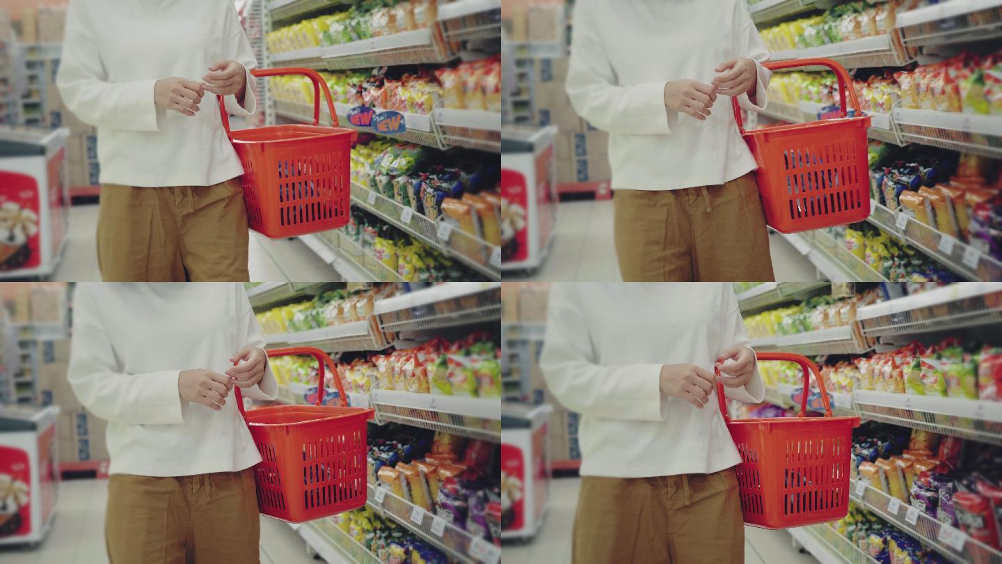 一名年轻女子戴着口罩在超市买干粮