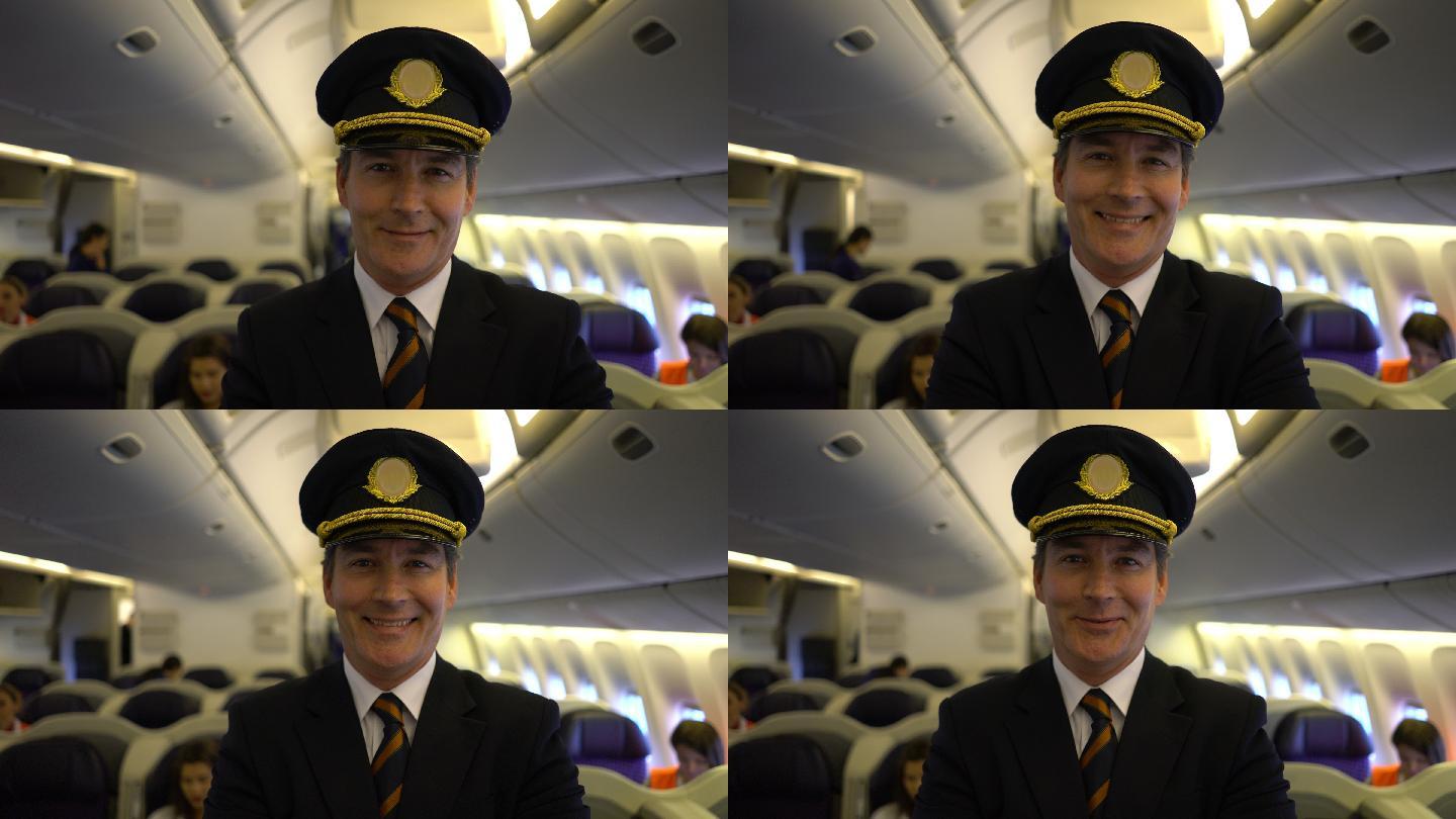 英俊的白人飞行员站在客舱，双臂交叉，对着摄像机微笑