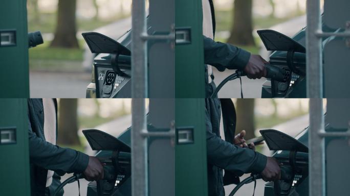 4k视频片段，一个面目全非的男子在车库为他的电动汽车充电时查看他的信息