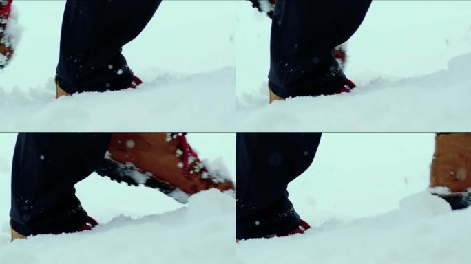 人的脚在雪山上行走的特写镜头。慢动作拍摄库存视频