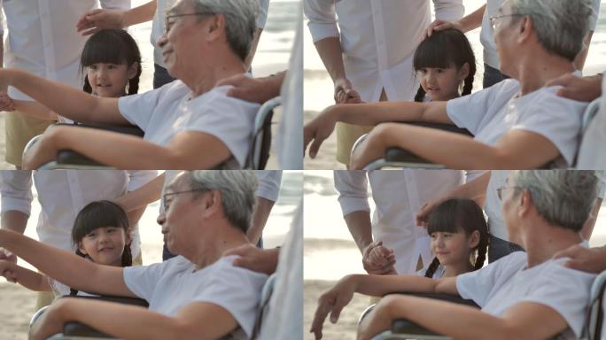欢乐的亚洲大家庭在日落的沙滩上冲浪。家庭、生活方式、人、人寿保险、多代人、老人、假期、关系、孩子、假
