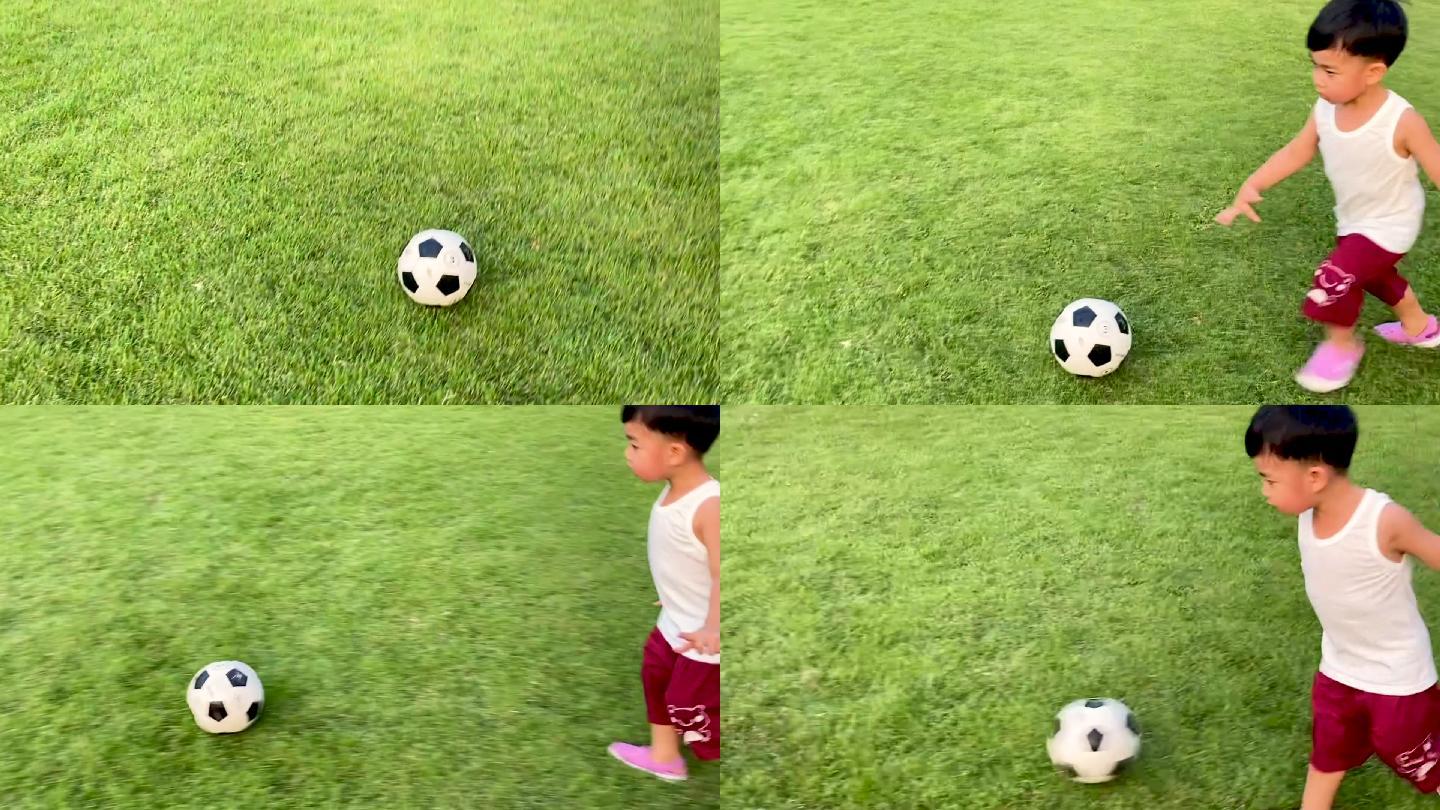 小男孩在草地上踢球。