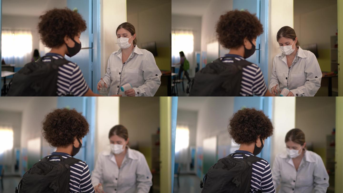 教师在进入教室前测量学生的体温-使用面罩
