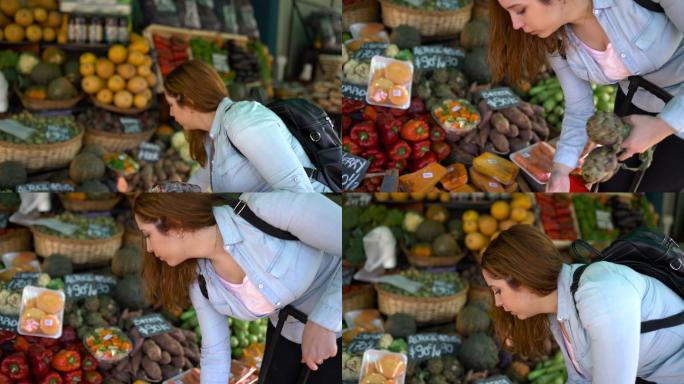 一位拉丁美洲女性素食主义者在一个小市场上购买蔬菜和水果，并把它们放进篮子里