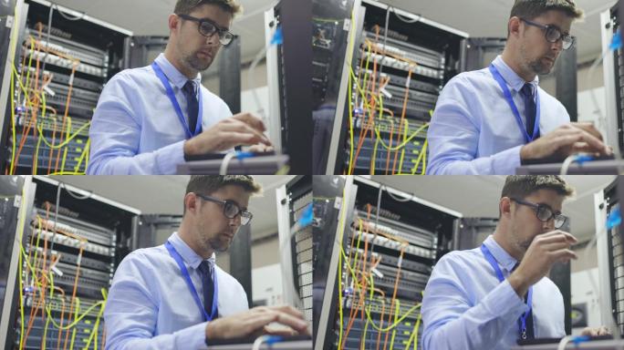 一名年轻IT技术人员独自站在服务器机房使用笔记本电脑的4k视频片段