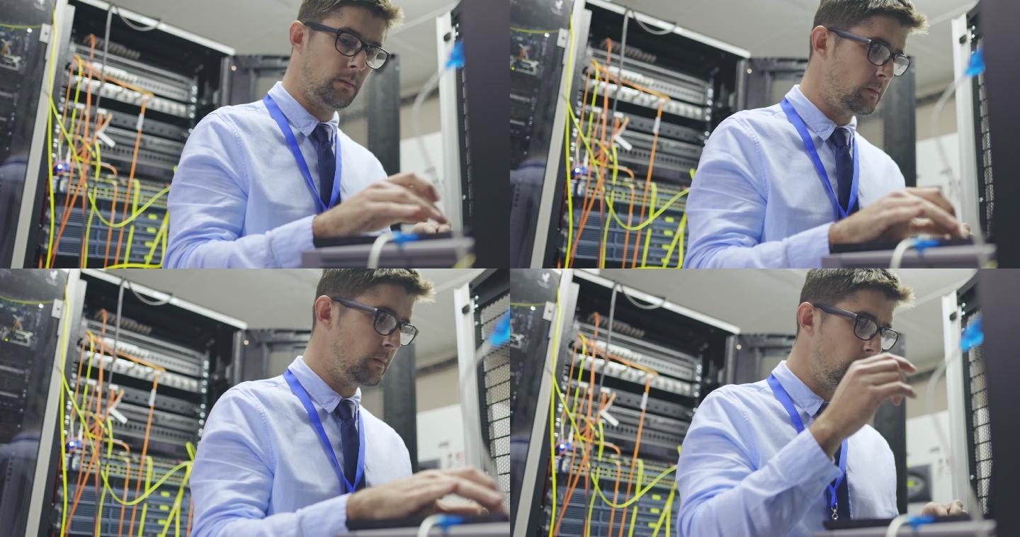 一名年轻IT技术人员独自站在服务器机房使用笔记本电脑的4k视频片段