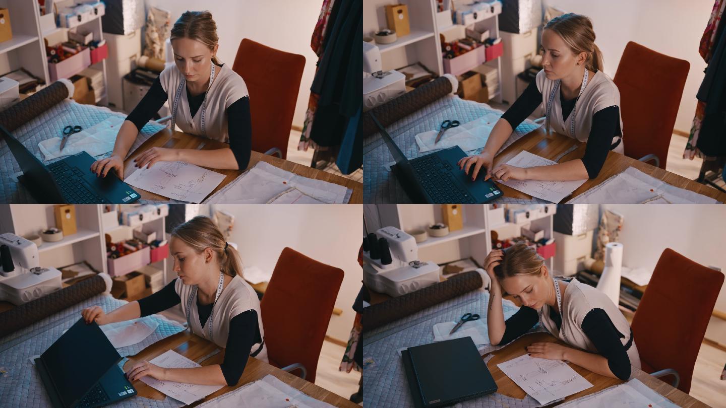 SLO MO精疲力竭的年轻女时装设计师在工作室里使用笔记本电脑