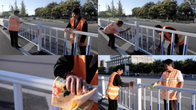 环卫工人打扫卫生净化城市擦洗路边护栏
