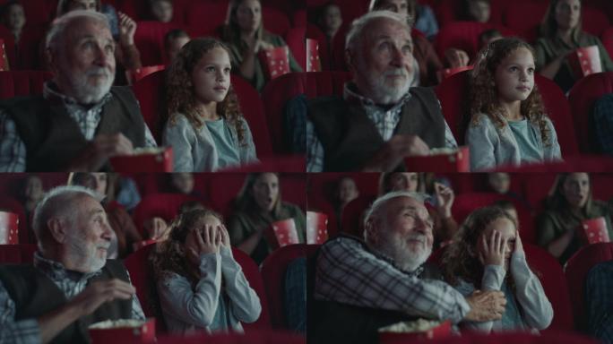 爷爷在电影院安慰受惊的女孩