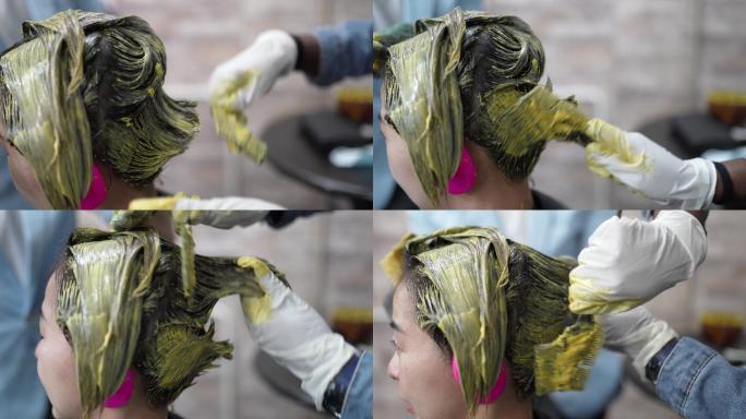 在美容店特写亚洲中国美女垂死的头发。