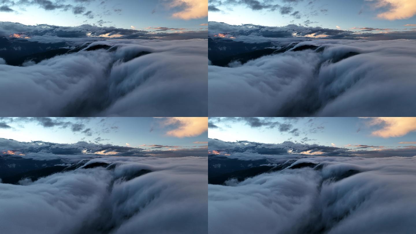 【4K正版】航拍日落阳光中的雪山云瀑