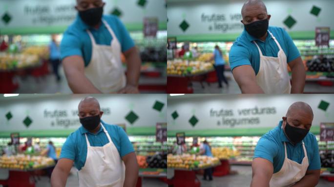 一名戴口罩的男子在超市整理蔬菜